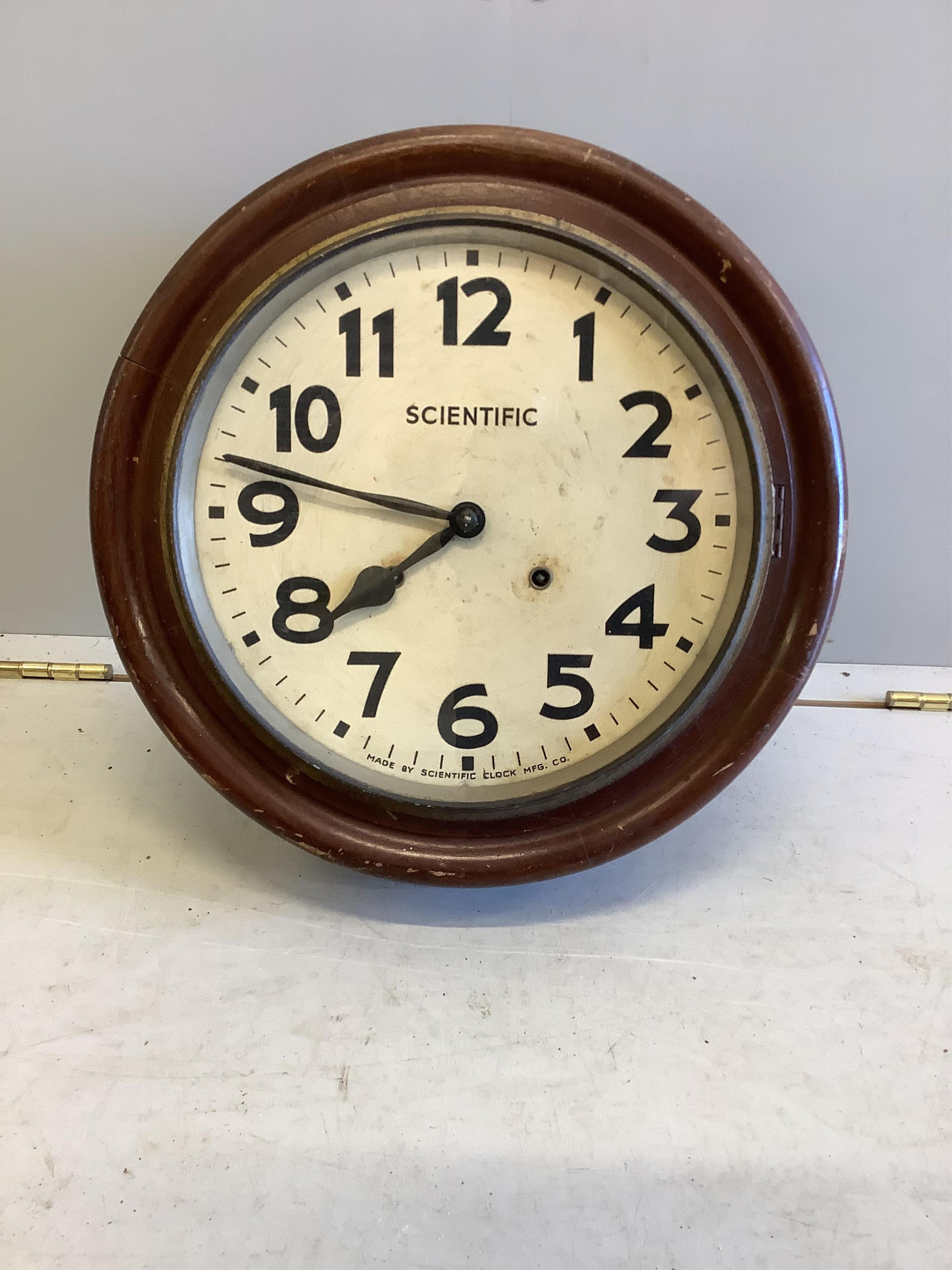A circular wall clock, marked Scientific, diameter 41cm depth 13cm